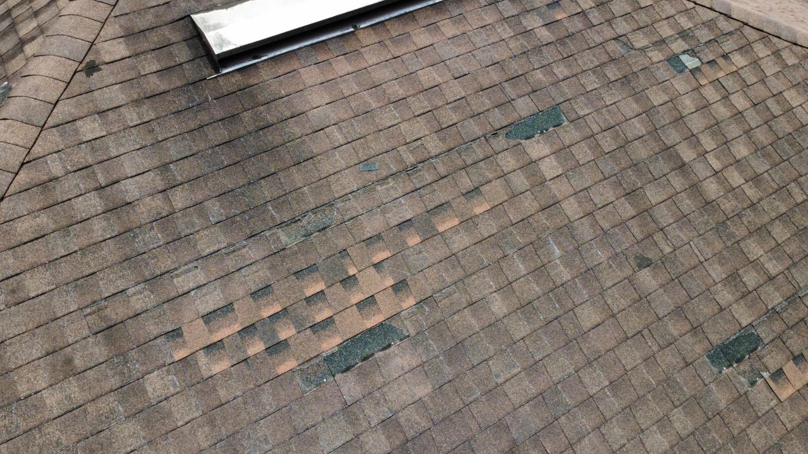 Hail and wind storm damage on a roof, Orlando FL